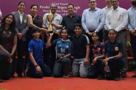 Students and officials pose with a trophy during the Annual Sports Awards Function at Delhi University.