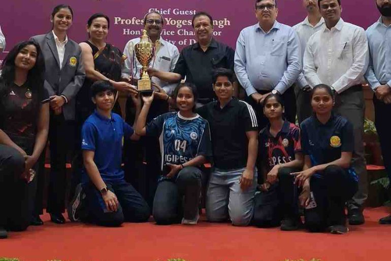 Students and officials pose with a trophy during the Annual Sports Awards Function at Delhi University.