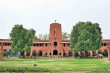 The Delhi University campus with its iconic red-brick academic building and central lawn.