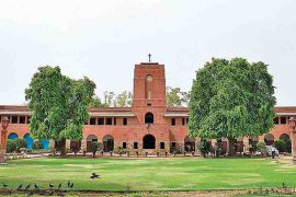 The Delhi University campus with its iconic red-brick academic building and central lawn.