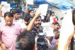 A group of students protesting in a crowded area with placards and media cameras during a demonstration related to NEET-UG 2026 concerns.