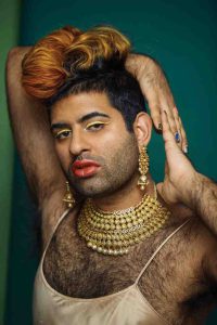 Alok Vaid-Menon poses wearing makeup, jewellery, and gender-fluid fashion.