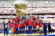 Spain players celebrate after winning the 2026 FIFA World Cup final, lifting the trophy during the presentation ceremony at New York New Jersey Stadium as FIFA President Gianni Infantino and U.S. President Donald Trump look on.