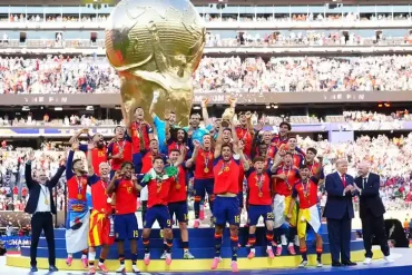 Spain players celebrate after winning the 2026 FIFA World Cup final, lifting the trophy during the presentation ceremony at New York New Jersey Stadium as FIFA President Gianni Infantino and U.S. President Donald Trump look on.