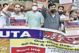 DUTA members protest against NEP 2020 and FYUP making a human chain at Mandi House in New Delhi.