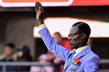 DR Congo superfan Michel Kuka Mboladinga stands motionless during a 2026 FIFA World Cup match.
