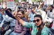 Teachers and protesters raise their voice while holding placards demanding the regularisation of ad hoc and temporary faculty at Delhi University.