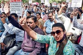 Teachers and protesters raise their voice while holding placards demanding the regularisation of ad hoc and temporary faculty at Delhi University.