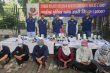 Delhi Police personnel with the seven accused arrested in connection with the alleged cyber-fraud network.